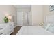 Bedroom with a white dresser, view into the bathroom, and neutral decor at 2116 Limestone Trl, Kissimmee, FL 34747