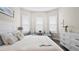 Bright bedroom with three windows, a ceiling fan, and neutral decor at 2116 Limestone Trl, Kissimmee, FL 34747