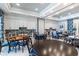 Inviting common area featuring multiple tables, chairs, white cabinets and colorful backsplash at 2116 Limestone Trl, Kissimmee, FL 34747