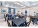 A well-lit common area features multiple tables and chairs, perfect for gathering and socializing at 2116 Limestone Trl, Kissimmee, FL 34747