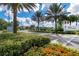 Well-maintained entrance to a gated community with lush landscaping and blooming flowers under sunny skies at 2116 Limestone Trl, Kissimmee, FL 34747