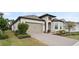 Beautiful single-story home featuring a paver driveway and a neatly landscaped front yard at 2116 Limestone Trl, Kissimmee, FL 34747