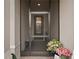 Inviting screened front entrance with a view into the foyer and a decorative floral arrangement at 2116 Limestone Trl, Kissimmee, FL 34747