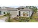 Charming home with a neutral color scheme, a well-manicured front yard, and a paved driveway leading to a two-car garage at 2116 Limestone Trl, Kissimmee, FL 34747