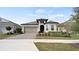 Charming single-Gathering home boasts a well-manicured front yard with a colorful landscaped garden at 2116 Limestone Trl, Kissimmee, FL 34747
