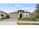Charming single-Gathering home boasts a well-manicured front yard and a welcoming two-car garage at 2116 Limestone Trl, Kissimmee, FL 34747