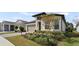 Charming single-Gathering home boasts a well-manicured front yard with a colorful landscaped garden at 2116 Limestone Trl, Kissimmee, FL 34747