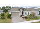 Charming single-Gathering home boasts a well-manicured front yard and a welcoming two-car garage at 2116 Limestone Trl, Kissimmee, FL 34747