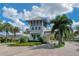 Charming guard house at the gated entrance, surrounded by palm trees and colorful landscaping at 2116 Limestone Trl, Kissimmee, FL 34747