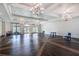 A grand hall with high ceilings, elegant chandeliers, and expansive windows offering bright natural light at 2116 Limestone Trl, Kissimmee, FL 34747