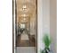 Elegant hallway with hardwood floors, stylish lighting, and a view towards the kitchen at 2116 Limestone Trl, Kissimmee, FL 34747