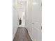 Hallway with hardwood floors, modern lighting and white trim at 2116 Limestone Trl, Kissimmee, FL 34747