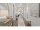 Bright and airy hallway with hardwood floors and decorative furnishings with a kitchen view at 2116 Limestone Trl, Kissimmee, FL 34747