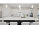 Spacious kitchen with a large island, white cabinets, stainless steel appliances, and modern pendant lights at 2116 Limestone Trl, Kissimmee, FL 34747