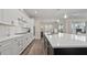 Modern kitchen with large island, stainless steel appliances, white cabinets, and pendant lighting at 2116 Limestone Trl, Kissimmee, FL 34747