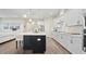 Open-concept kitchen with white cabinetry, a large island with seating, and stainless steel appliances at 2116 Limestone Trl, Kissimmee, FL 34747