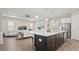 Bright, open living space with a large island, seating, and modern stainless steel appliances at 2116 Limestone Trl, Kissimmee, FL 34747