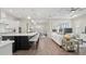 Open floor plan with kitchen island, dining, and living areas. Hardwood floors and lots of light at 2116 Limestone Trl, Kissimmee, FL 34747