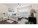 Bedroom with a ceiling fan, shuttered windows, accent chair, and decorative rug at 2116 Limestone Trl, Kissimmee, FL 34747