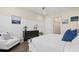 Comfortable bedroom with a white chair, board and batten accent wall, and dark wood flooring at 2116 Limestone Trl, Kissimmee, FL 34747