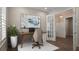 Home office with French doors, a modern desk, and an abstract painting at 2116 Limestone Trl, Kissimmee, FL 34747