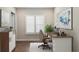 Home office featuring a modern desk, abstract painting, and natural light at 2116 Limestone Trl, Kissimmee, FL 34747