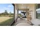 Screened patio with brick floor, view of backyard, rocking chair, and cat tree for comfortable outdoor living at 2116 Limestone Trl, Kissimmee, FL 34747