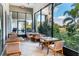 Inviting patio area with wood tables and chairs, offering scenic views of the lush landscape at 2116 Limestone Trl, Kissimmee, FL 34747