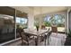 Covered patio with brick floor, dining table, and outdoor seating, perfect for relaxing and entertaining at 2116 Limestone Trl, Kissimmee, FL 34747