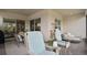 Screened patio with brick floor, rocking chairs, dining table, and a daybed for relaxing outdoor lounging at 2116 Limestone Trl, Kissimmee, FL 34747