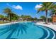 Inviting community pool with clear water, palm trees, and lounge chairs under a sunny sky at 2116 Limestone Trl, Kissimmee, FL 34747