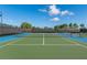 Well-maintained tennis courts with a blue and green surface, perfect for recreational play at 2116 Limestone Trl, Kissimmee, FL 34747