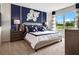 This primary bedroom boasts a bright accent wall and a view overlooking the lush greenery outside at 2223 Lake Preserve Cir, New Smyrna Beach, FL 32168