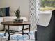 Close up of a cozy living room features a round wooden coffee table with a plant, modern decor and comfortable seating at 2223 Lake Preserve Cir, New Smyrna Beach, FL 32168