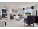 Bright living room with a view into the main bedroom, tile floors, neutral walls, and white sofa with blue accents at 2223 Lake Preserve Cir, New Smyrna Beach, FL 32168