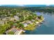 This aerial shot captures a neighborhood with lakefront homes, featuring private docks, pools, and lush landscaping, offering a serene lifestyle at 2504 Gatlin Ave, Orlando, FL 32806