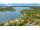This aerial shot reveals a picturesque lake community, showcasing waterfront homes with docks and pools, surrounded by lush greenery and sparkling waters at 2504 Gatlin Ave, Orlando, FL 32806