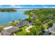 Sweeping aerial view of the waterfront estate featuring a private lake and manicured grounds at 2504 Gatlin Ave, Orlando, FL 32806