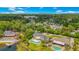 A stunning aerial view of a lakeside property featuring a private pool, dock, and lush landscaping, all set against a backdrop of a vibrant city skyline at 2504 Gatlin Ave, Orlando, FL 32806