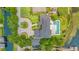 An aerial view of an estate home, manicured grounds and a pool, overlooking the pristine lake at 2504 Gatlin Ave, Orlando, FL 32806