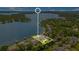 An aerial view spotlights a lakeside home, highlighting its pool, manicured lawn, and waterfront location, offering a blend of luxury and natural beauty at 2504 Gatlin Ave, Orlando, FL 32806