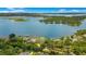 A picturesque aerial view of a lakefront property with swimming pool, private dock, and lush greenery, offering an exclusive waterfront lifestyle at 2504 Gatlin Ave, Orlando, FL 32806