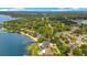 A captivating aerial view featuring lakefront homes with mature trees, swimming pools, and lush landscaping, creating a beautiful and inviting atmosphere at 2504 Gatlin Ave, Orlando, FL 32806