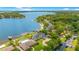 Stunning aerial shot of an expansive lakeside property with a luxurious home and pool at 2504 Gatlin Ave, Orlando, FL 32806
