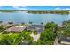 Breathtaking aerial view of a lakeside estate with lush landscaping and a circular driveway at 2504 Gatlin Ave, Orlando, FL 32806