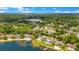 Enjoy this aerial view of a waterfront community with well-maintained homes, lush greenery, and city skyline, providing a blend of nature and urban life at 2504 Gatlin Ave, Orlando, FL 32806