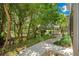 Lush green backyard with a winding path leading to a cozy gazebo at 2504 Gatlin Ave, Orlando, FL 32806