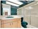 Retro bathroom features a vanity sink with a matching toilet and shower stall at 2504 Gatlin Ave, Orlando, FL 32806