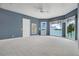 Spacious bedroom with lake views, a ceiling fan, and balcony access at 2504 Gatlin Ave, Orlando, FL 32806
