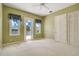Light green bedroom featuring a ceiling fan, ensuite balcony access, and double door closet at 2504 Gatlin Ave, Orlando, FL 32806